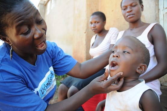 18169685891_2de0aea320_o Living Goods community health worker looking in little boy's mouth