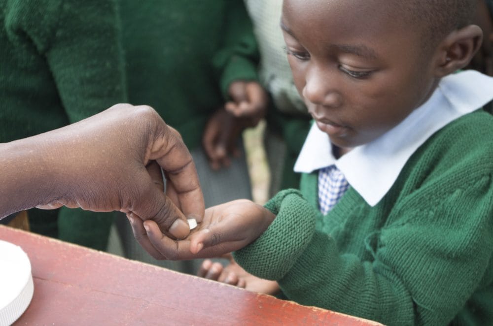 Child taking deworming tablet