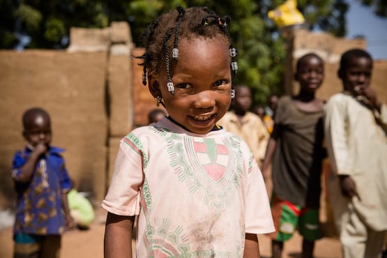 Little girl in pink dress smiling