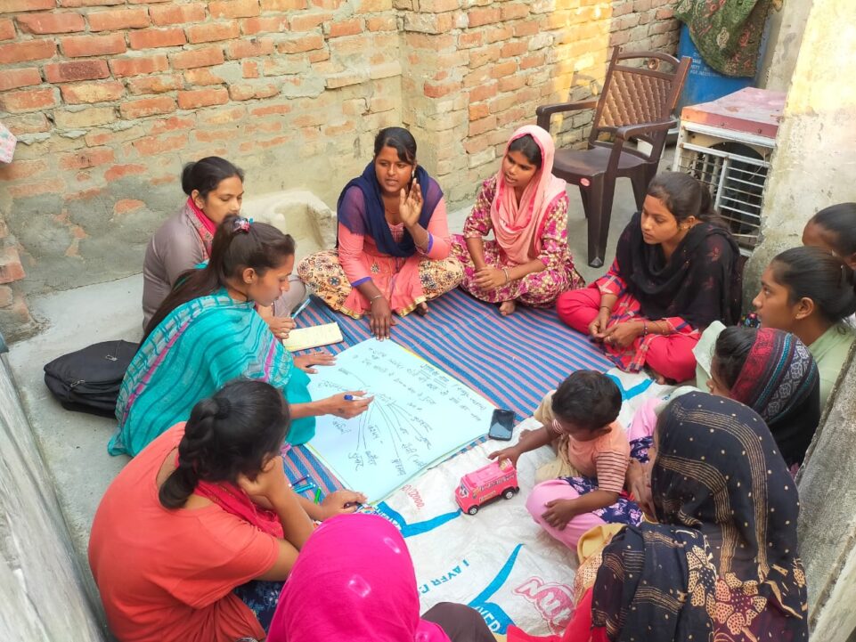 Community developer performing PRA activity (Participatory Rural Appraisal) with the Youth group of Raipur Jathan village in Karnal district