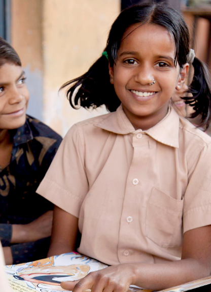 A smiling schoolgirl with her classmates